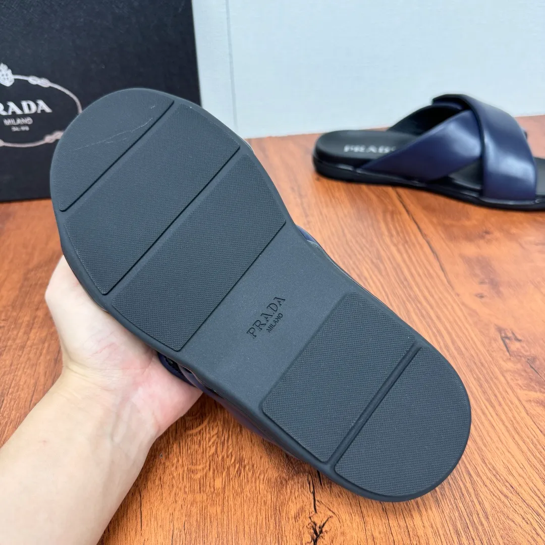 Batch 580 Prada/Prada's new men's leather cross slippers. Velcro closure can finely adjust the size. Calf leather light luxury slippers. Thick soft calf leather wraps the upper. Fat but soft rubber lazy style, soft and comfortable, excellent foot feel. Genuine leather bottom layer, cross style, with a Velcro closure buckle, easy to adjust the appropriate size, and a perfect fit for the wearing experience. The enamel gold triangle logo highlights the brand's classic features. Lightweight rubber thin sole, high foot comfort! Complete package! Size: 39-40-41-42-43-44-45 Leather shoe size Item number: 2X7132 Blue